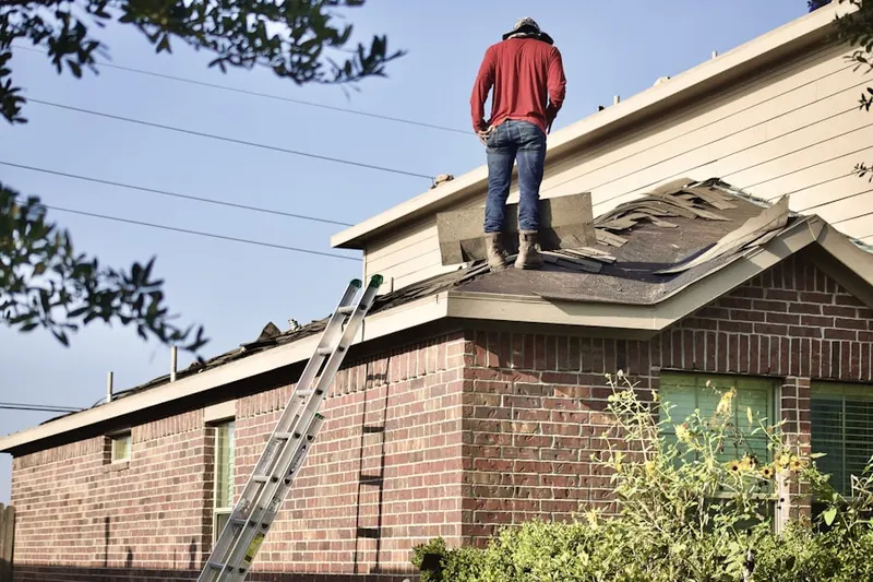 Professional roofer working on a residential roof in Meadowview